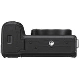 Black mirrorless camera body side showing textured grip and port cover