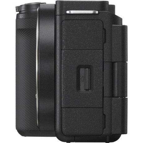 Black mirrorless camera body side with access door and textured grip