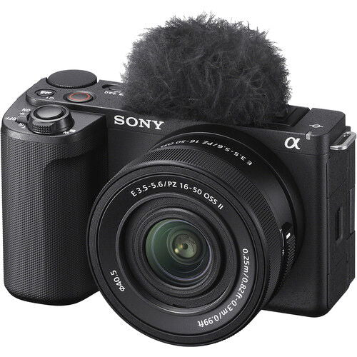 Black mirrorless camera with 16–50mm lens and furry microphone on top