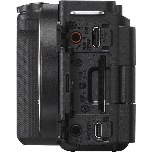 Rear/side ports view of black mirrorless camera body with connectors under covers