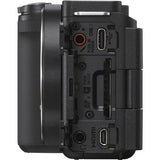 Rear/side ports view of black mirrorless camera body with connectors under covers