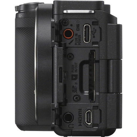 Rear/side ports view of black mirrorless camera body with connectors under covers