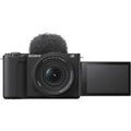 Mirrorless camera kit with 16–50mm zoom lens and flip-up screen, black