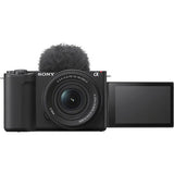 Mirrorless camera kit with 16–50mm zoom lens and flip-up screen, black