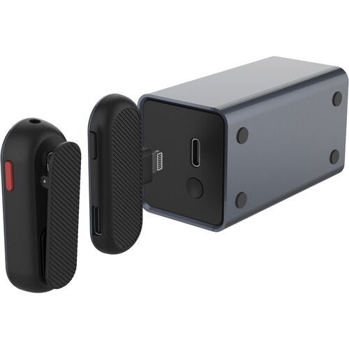 Wireless lavalier mic receiver and transmitter pods with visible ports, close angle
