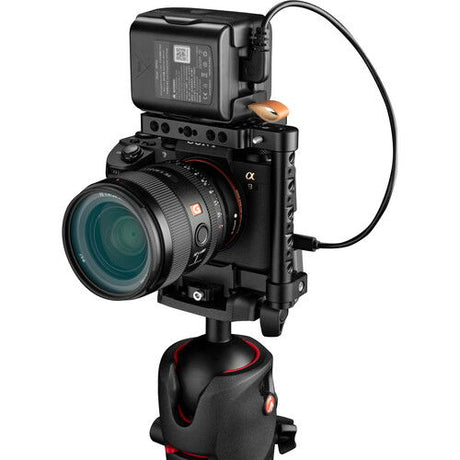 Battery bank attached to camera top, angled view with power cables