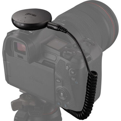 Syrp Genie Micro Camera Control puck connected to camera via coiled cable