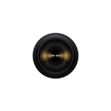 Front view of black telephoto zoom lens with glass element and lens hood ring