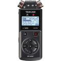 Tascam portable audio recorder with LCD screen, transport buttons, and two metal mic caps