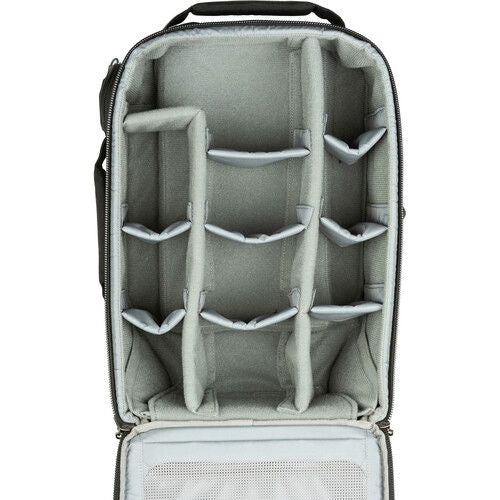 Interior view: gray organizer panels and mesh pockets in dark rolling backpack