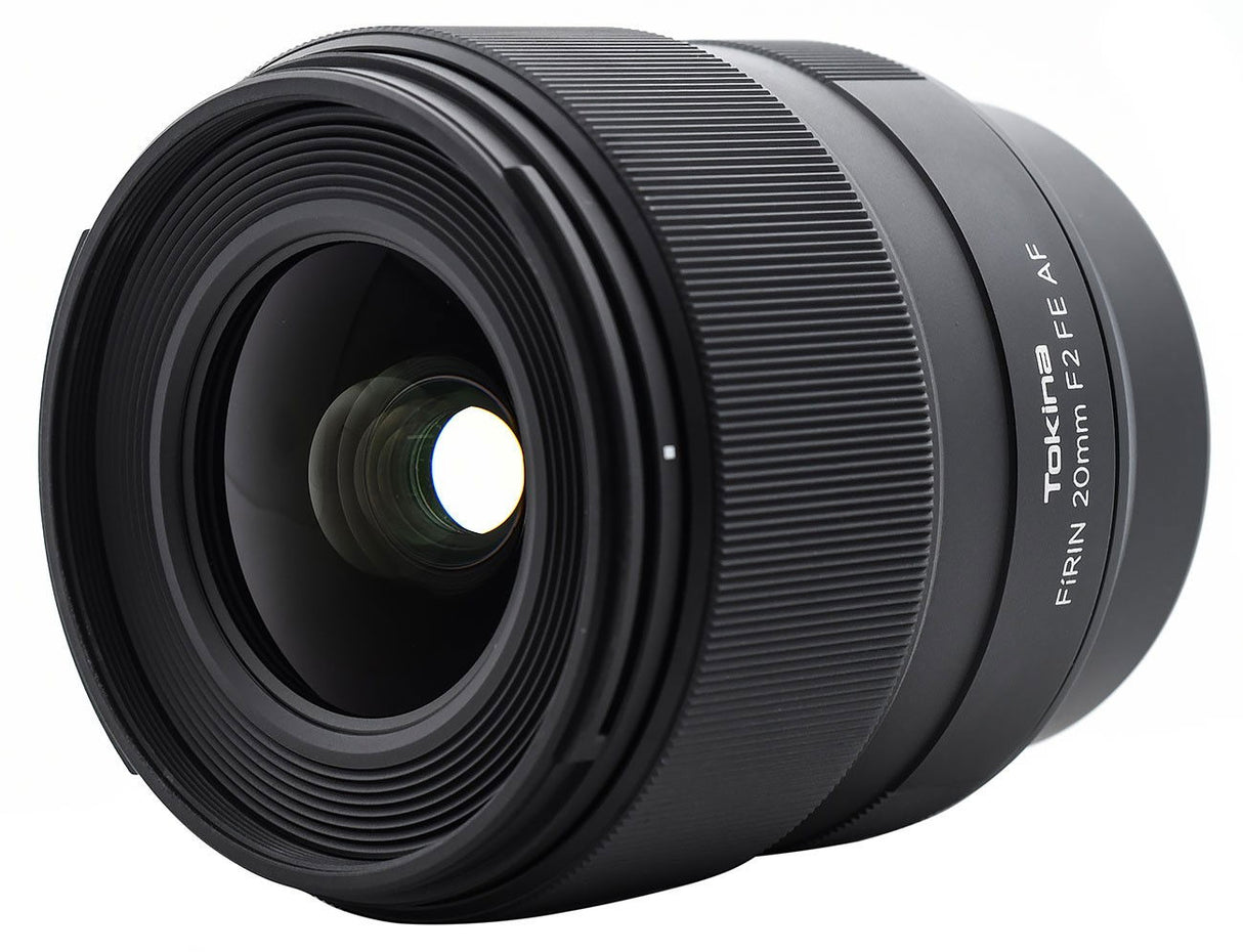 FiRIN 20mm f/2 FE AF lens, angled view showing front glass and ridged focus ring