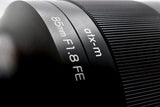 Engraved 85mm and F1.8 labels on atx-m lens barrel with textured focus ring