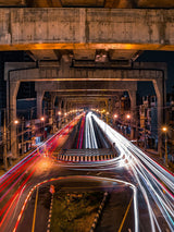 Bridge view with long-exposure light trails from passing vehicles