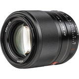 Front view of black 56mm f/1.4 AF lens with glass element and focus scale