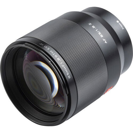 Black 85mm f/1.8 lens close side angle showing textured grip and front element