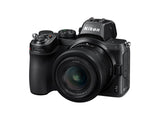 Black mirrorless camera kit with 24-50mm zoom lens, three-quarter angle