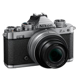 Front view mirrorless camera kit with black textured body and attached zoom lens