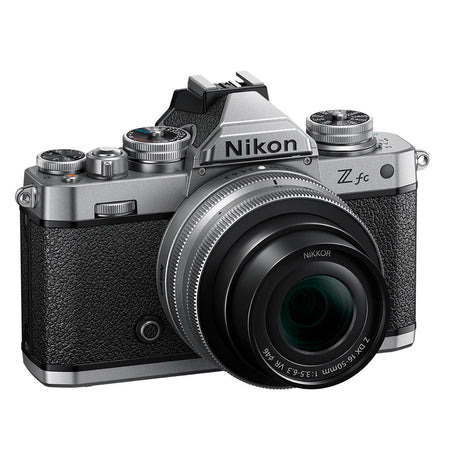 Front view mirrorless camera kit with black textured body and attached zoom lens