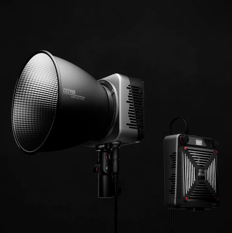 Bi-color LED light on stand with reflector; compact LED panel shown beside it