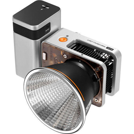Silver RGB LED light with black lens, orange ring, and front honeycomb reflector
