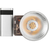 Silver cylindrical LED fixture with front reflector and warm white LED array