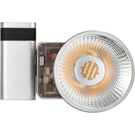 Silver cylindrical LED fixture with front reflector and warm white LED array