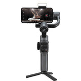 Smartphone gimbal stabilizer with phone mounted and three-axis arms on tripod base