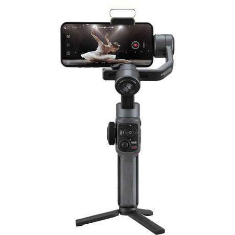 Smartphone gimbal stabilizer with phone mounted and three-axis arms on tripod base