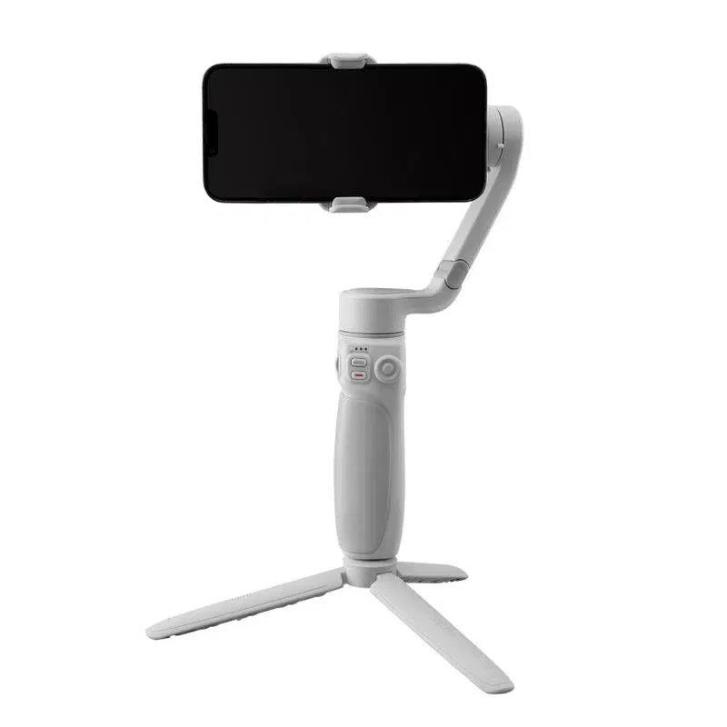 Light gray smartphone gimbal stabilizer with black phone mounted on a 3-leg base