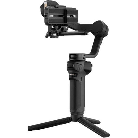 Black handheld gimbal with LED panel, camera mount and tripod-style base legs