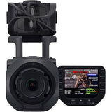 Q8n-4K video recorder with lens front and LCD display showing scene options